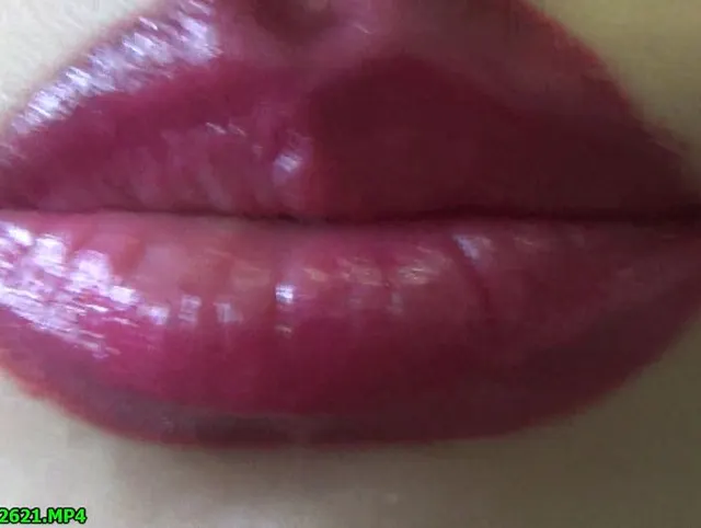 Spit play with a big painted by lipstick lips
